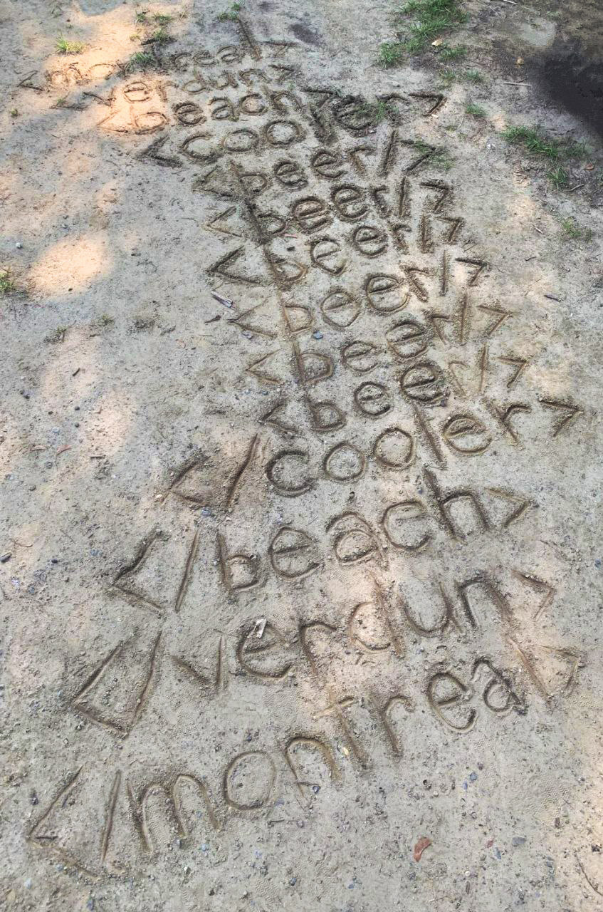 HTML elements written repeatedly in the sand at the beach